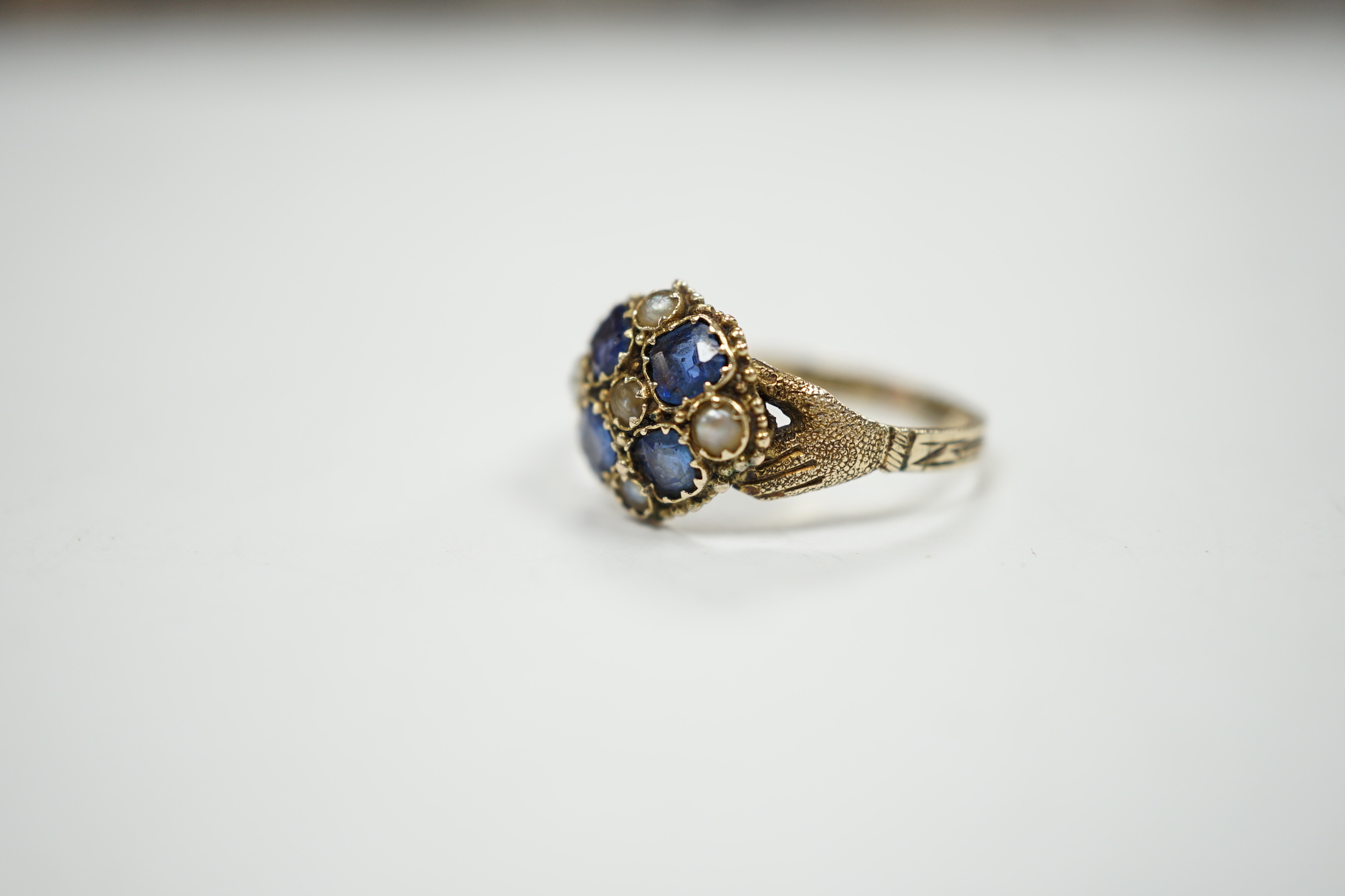 A Victorian 12ct gold sapphire and seed pearl cluster set ring, size M, gross weight 1.6 grams.